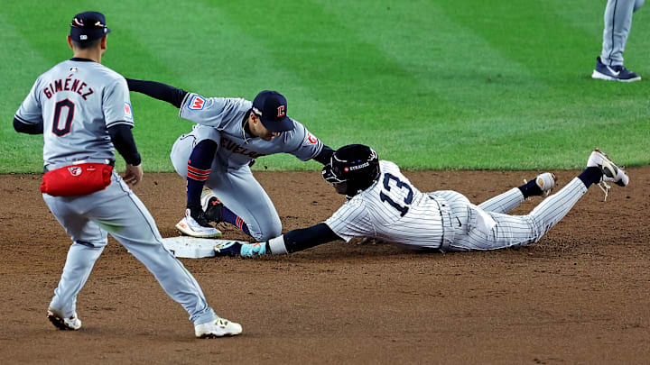 Oct 15, 2024; Bronx, New York, USA; New York Yankees third base Jazz Chisholm Jr. (13) is tagged out by Cleveland Guardians shortstop Brayan Rocchio (4) at second base during the sixth inning in game two of the ALCS for the 2024 MLB Playoffs at Yankee Stadium. Mandatory Credit: Brad Penner-Imagn Images