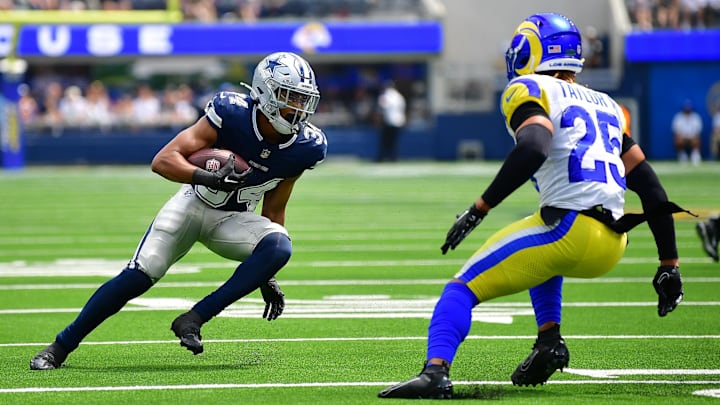 Dallas Cowboys running back Malik Davis runs the ball against Los Angeles Rams safety Jason Taylor II.