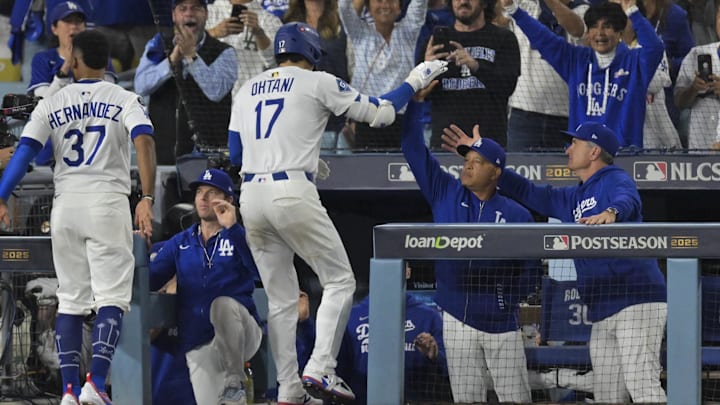 Oct 17, 2025; Los Angeles, California, USA; Los Angeles Dodgers two-way player Shohei Ohtani (17) high fives manager Dave Roberts (30) after his solo home run against the Milwaukee Brewers during the fourth inning of game four of the NLCS round for the 2025 MLB playoffs at Dodger Stadium. Mandatory Credit: Jayne Kamin-Oncea-Imagn Images