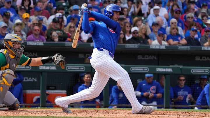 Mar 14, 2024; Mesa, Arizona, USA; Chicago Cubs center fielder Cody Bellinger (24) hits a single