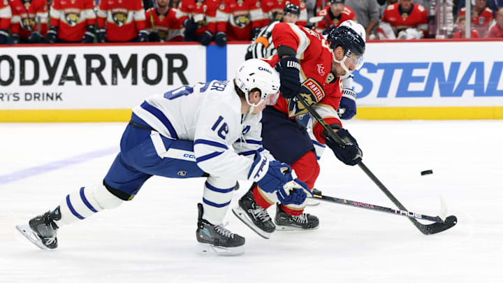 May 11, 2025; Sunrise, Florida, USA; Toronto Maple Leafs defenseman Chris Tanev (8) and right wing Mitch Marner (16) defend Florida Panthers center Brad Marchand (63) during the second period in game four of the second round of the 2025 Stanley Cup Playoffs at Amerant Bank Arena. Mandatory Credit: Kim Klement Neitzel-Imagn Images