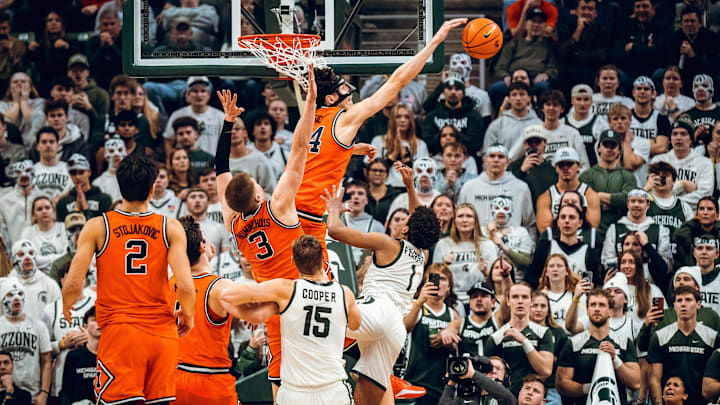 Illinois forward Zvonimir Ivisic swats away a shot from Michigan State guard Jeremy Fears Jr. (1) in the Illini's 85-82 loss to the Spartans on Saturday at the Breslin Center in East Lansing, Michigan,