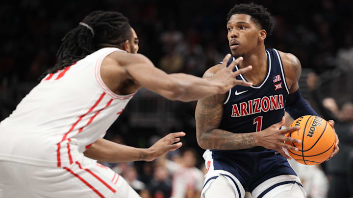 Arizona Wildcats guard Caleb Love (1) attempts to dribble the ball past Houston Cougars forward Joseph Tugler (11) during the second half for the Big 12 Conference Tournament Championship game at T-Mobile Center. Arizona Wildcats guard Caleb Love (1) attempts to dribble the ball past Houston Cougars forward Joseph Tugler (11) during the second half for the Big 12 Conference Tournament Championship game at T-Mobile Center.