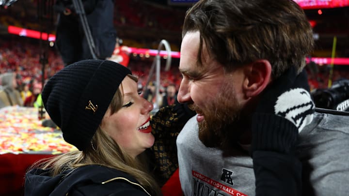 Jan 26, 2025; Kansas City, MO, USA; Recording artist Taylor Swift  and Kansas City Chiefs tight end Travis Kelce (87) react after the AFC Championship game against the Buffalo Bills at GEHA Field at Arrowhead Stadium. Mandatory Credit: Mark J. Rebilas-Imagn Images
