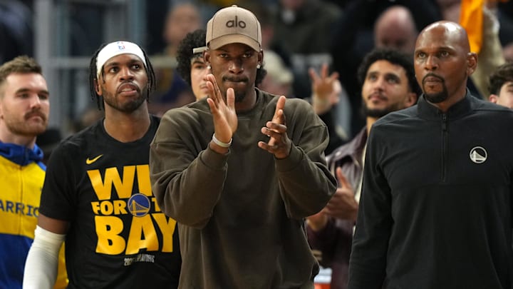 Apr 26, 2025; San Francisco, California, USA; Golden State Warriors forward Jimmy Butler III (center) applauds from the bench against the Houston Rockets during the third quarter of game three of first round for the 2024 NBA Playoffs at Chase Center. Mandatory Credit: Darren Yamashita-Imagn Images