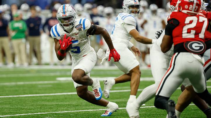 Jan 1, 2026; New Orleans, LA, USA; Rebels running back Kewan Lacy (5) carries the ball en route to a touchdown past Georgia Bulldogs safety Rasean Dinkins (27) in the third quarter during the 2025 Sugar Bowl and quarterfinal game of the College Football Playoff at Caesars Superdome. Mandatory Credit: Geoff Burke-Imagn Images Jan 1, 2026; New Orleans, LA, USA; Rebels running back Kewan Lacy (5) carries the ball en route to a touchdown past Georgia Bulldogs safety Rasean Dinkins (27) in the third quarter during the 2025 Sugar Bowl and quarterfinal game of the College Football Playoff at Caesars Superdome. Mandatory Credit: Geoff Burke-Imagn Images