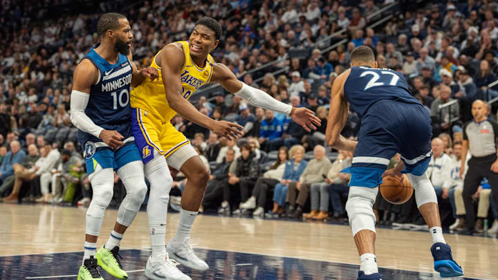 Dec 13, 2024; Minneapolis, Minnesota, USA; Los Angeles Lakers forward Rui Hachimura (28) loses control of the ball under the defense of Minnesota Timberwolves guard Mike Conley (10) and center Rudy Gobert (27) in the second quarter at Target Center. Mandatory Credit: Matt Blewett-Imagn Images