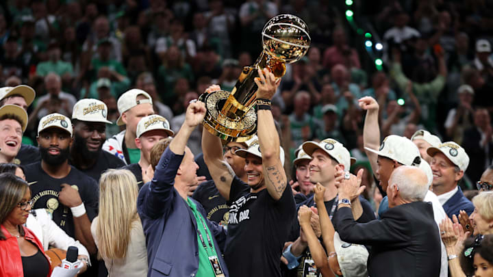 Jun 17, 2024; Boston, Massachusetts, USA; Boston Celtics head coach Joe Mazzulla holds up the trophy as he celebrates after winning the 2024 NBA Finals against the Dallas Mavericks at TD Garden. Mandatory Credit: Peter Casey-Imagn Images