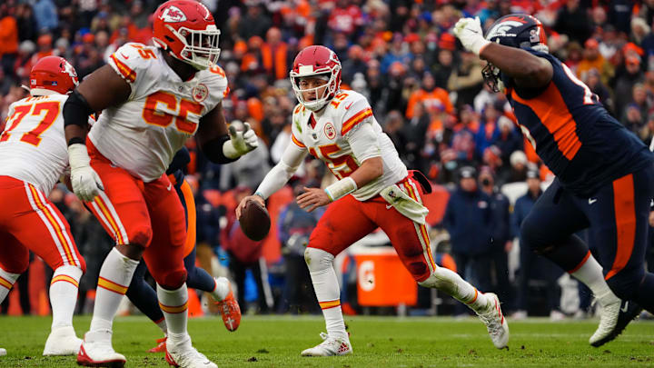Jan 8, 2022; Denver, Colorado, USA; Kansas City Chiefs quarterback Patrick Mahomes (15) scrambles with the ball as guard Trey Smith (65) defends against Denver Broncos defensive end Shelby Harris (96) in the second quarter at Empower Field at Mile High. Mandatory Credit: Ron Chenoy-Imagn Images Jan 8, 2022; Denver, Colorado, USA; Kansas City Chiefs quarterback Patrick Mahomes (15) scrambles with the ball as guard Trey Smith (65) defends against Denver Broncos defensive end Shelby Harris (96) in the second quarter at Empower Field at Mile High. Mandatory Credit: Ron Chenoy-Imagn Images