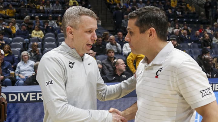 Jan 6, 2026; Morgantown, West Virginia, USA; West Virginia Mountaineers head coach Ross Hodge talks with Cincinnati Bearcats head coach Wes Miller before the game at Hope Coliseum. Jan 6, 2026; Morgantown, West Virginia, USA; West Virginia Mountaineers head coach Ross Hodge talks with Cincinnati Bearcats head coach Wes Miller before the game at Hope Coliseum.