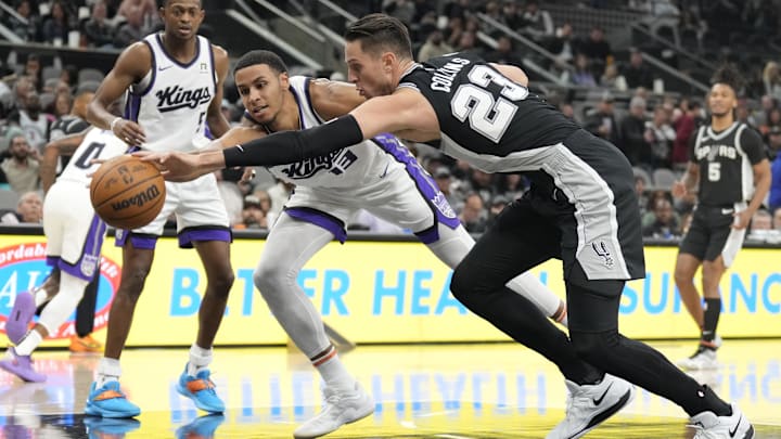 Dec 6, 2024; San Antonio, Texas, USA; Sacramento Kings forward Keegan Murray (13) and San Antonio Spurs center Zach Collins (23) battle for a loose ball during the first half at Frost Bank Center.