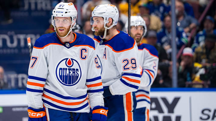 May 16, 2024; Vancouver, British Columbia, CAN; Edmonton Oilers forward Connor McDavid (97) and forward Leon Draisaitl (29) and defenseman Evan Bouchard (2) during a stop in play against the Vancouver Canucks during the first period in game five of the second round of the 2024 Stanley Cup Playoffs at Rogers Arena. Mandatory Credit: Bob Frid-Imagn Images