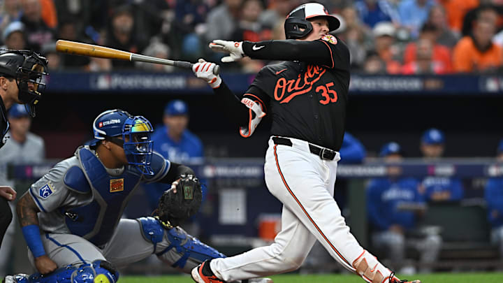 Oct 2, 2024; Baltimore, Maryland, USA; Baltimore Orioles catcher Adley Rutschman (35) hits a single against the Kansas City Royals in the fourth inning in game two of the Wild Card round for the 2024 MLB Playoffs at Oriole Park at Camden Yards. 