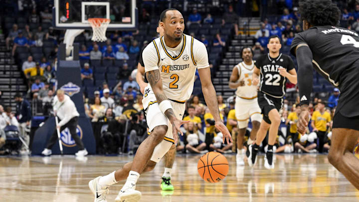 Former Mizzou Tiger guard Tamar Bates (2) drives to the basket against a defender, in a game versus the Mississippi State Bulldogs, in the second round of the SEC Tournament last season.