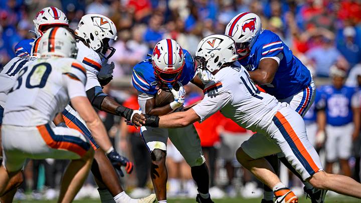 Oct 17, 2026; Dallas, Texas, USA; Virginia Cavaliers defensive end Fisher Camac (14) tackles SMU Mustangs running back Kendrick Raphael (6) during the first half at Gerald J. Ford Stadium. Mandatory Credit: Jerome Miron-Imagn Images Oct 17, 2026; Dallas, Texas, USA; Virginia Cavaliers defensive end Fisher Camac (14) tackles SMU Mustangs running back Kendrick Raphael (6) during the first half at Gerald J. Ford Stadium. Mandatory Credit: Jerome Miron-Imagn Images