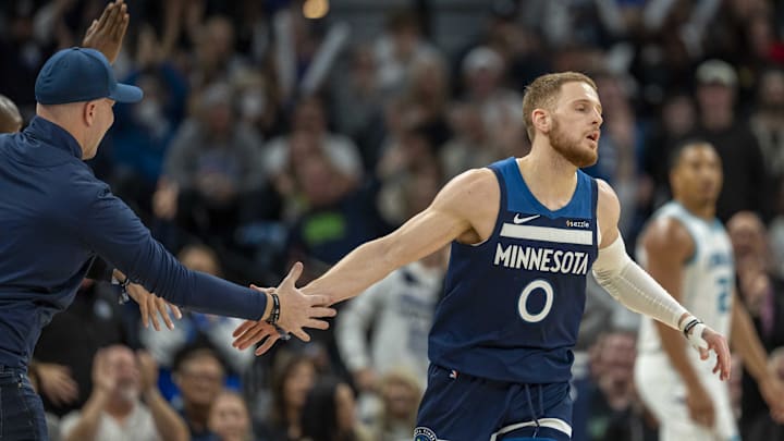 Minnesota Timberwolves guard Donte DiVincenzo shakes hands with a fan after making a shot against the Charlotte Hornets in the second half at Target Center in Minneapolis on Nov. 4, 2024.