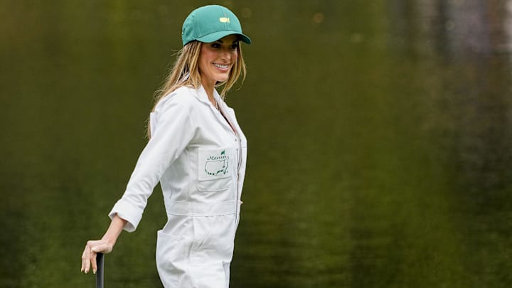 Jena Sims, wife of Brooks Koepka, stands on the no. 9 green during the Par 3 Contest at Augusta National Golf Club.