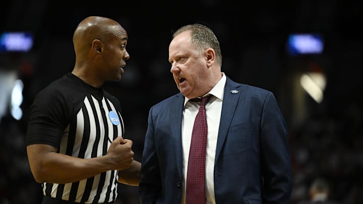 Mar 19, 2026; Portland, OR, USA; Wisconsin Badgers head coach Greg Gard talks with an official during the second half of a first round game of the men's 2026 NCAA Tournament against the High Point Panthers at Moda Center. Mandatory Credit: Troy Wayrynen-Imagn Images