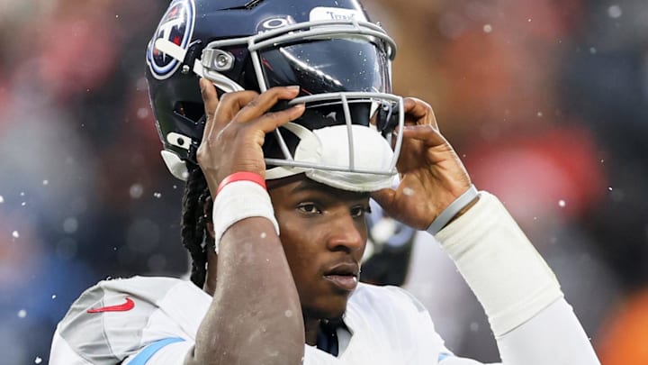 Dec 7, 2025; Cleveland, Ohio, USA; Tennessee Titans quarterback Cam Ward (1) puts on his helmet against the Cleveland Browns during the third quarter at Huntington Bank Field. Mandatory Credit: Scott Galvin-Imagn Images