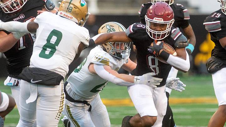 Louisville's Zaiden Jernigan pops through a hole in a 2024 game. 