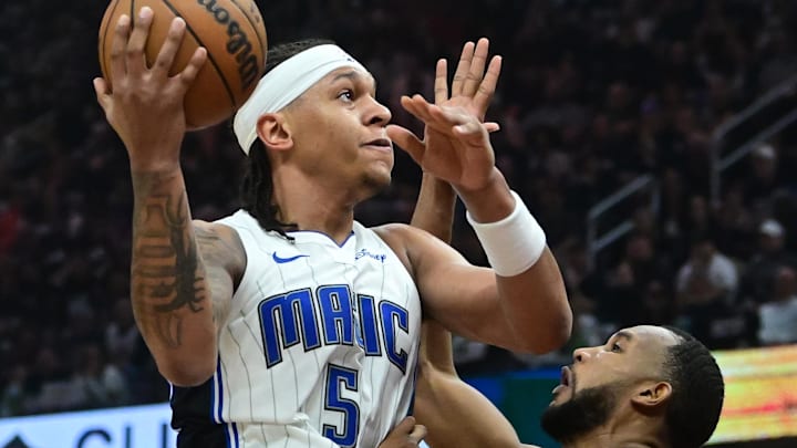 May 5, 2024; Cleveland, Ohio, USA; Orlando Magic forward Paolo Banchero (5) drives to the basket against Cleveland Cavaliers forward Evan Mobley (4) during the first half in game seven of the first round for the 2024 NBA playoffs at Rocket Mortgage FieldHouse. Mandatory Credit: Ken Blaze-Imagn Images