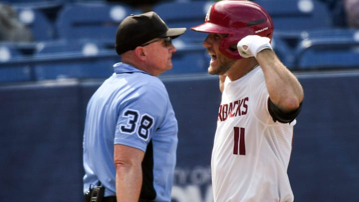 Arkansas batter Jared Wegner celebrates after hitting a grand slam homer against Arkansas during the