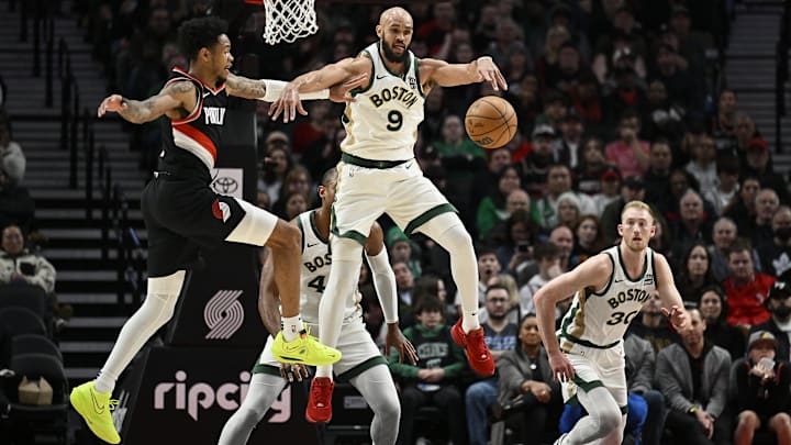 Mar 11, 2024; Portland, Oregon, USA: Boston Celtics guard Derrick White (9) steals a pass during the first half against Portland Trail Blazers guard Anfernee Simons (1) at Moda Center. Mandatory Credit: Troy Wayrynen-Imagn Images