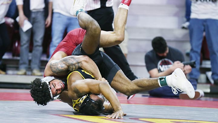Iowa State Cyclones Anthony Echemendia takes down Missouri Tigers' Josh Edmond during their 141-pound wrestling in the Big-12-conference showdown at Hilton Coliseum on Sunday, Feb. 25, 2024, in Ames, Iowa