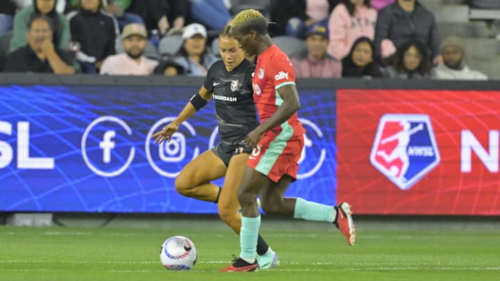 Angel City FC defender Sarah Gorden (11) plays theball defend by Kansas City Current forward Temwa Chawinga (6) 