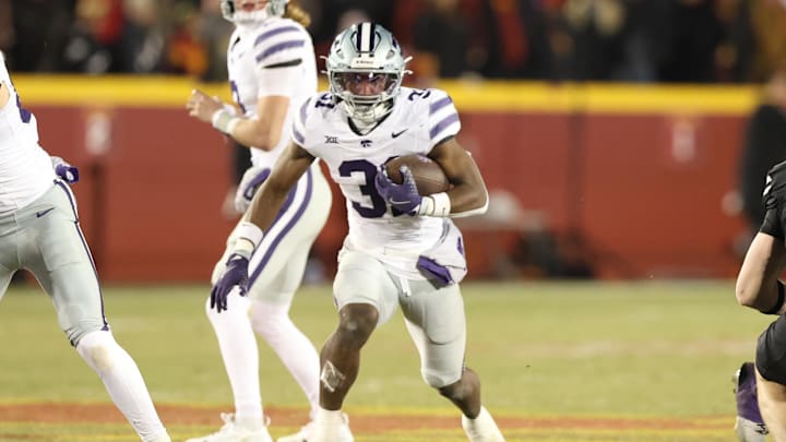 Nov 30, 2024; Ames, Iowa, USA;  Kansas State Wildcats running back DJ Giddens (31) runs the football against the Iowa State Cyclones in the first quarter at at Jack Trice Stadium. Mandatory Credit: Reese Strickland-Imagn Images