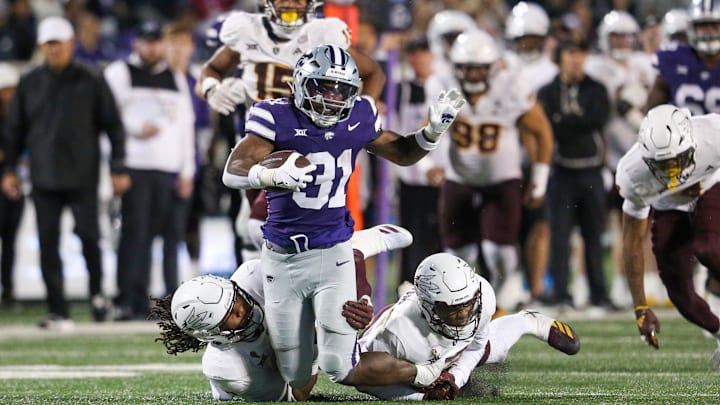 Nov 16, 2024; Manhattan, Kansas, USA; Kansas State Wildcats running back DJ Giddens (31) is tackled by Arizona State Sun Devils defensive lineman Clayton Smith (10) and defensive back Xavion Alford (2) during the third quarter at Bill Snyder Family Football Stadium. Mandatory Credit: Scott Sewell-Imagn Images