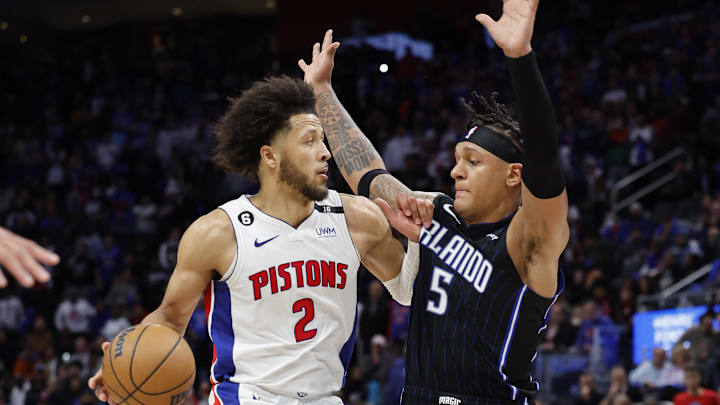 Oct 19, 2022; Detroit, Michigan, USA;  Detroit Pistons guard Cade Cunningham (2) is defended by Orlando Magic forward Paolo Banchero (5): Rick Osentoski-Imagn Images