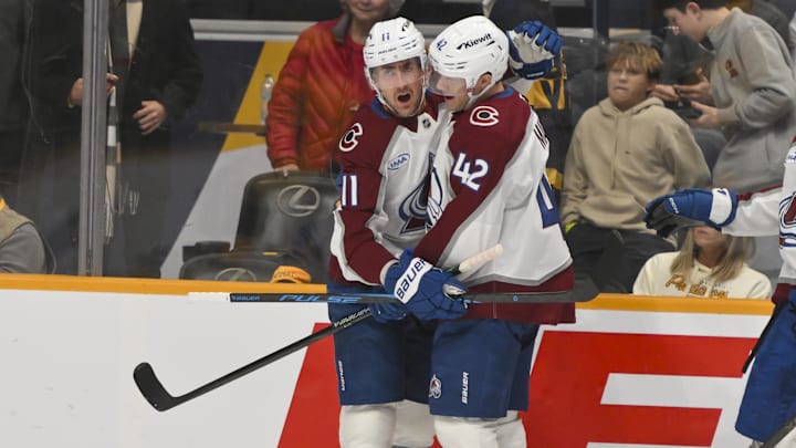 Dec 9, 2025; Nashville, Tennessee, USA;  Colorado Avalanche center Brock Nelson (11) celebrates his goal with defenseman Josh Manson (42) against the Nashville Predators during the first period at Bridgestone Arena. Mandatory Credit: Steve Roberts-Imagn Images