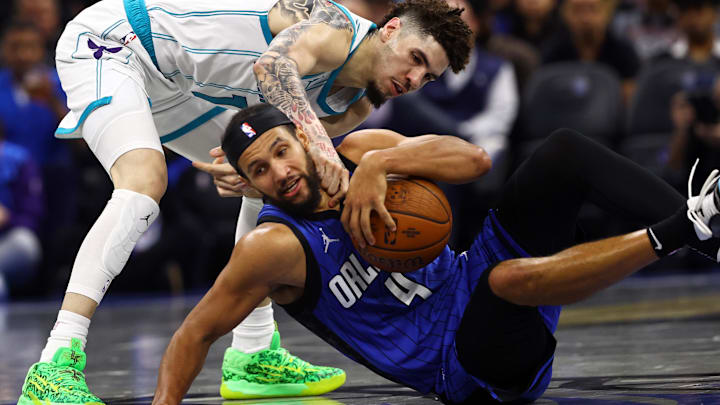 Nov 12, 2024; Orlando, Florida, USA; Charlotte Hornets guard LaMelo Ball (1) and Orlando Magic guard Jalen Suggs (4) go after the loose ball during the second half at Kia Center. Mandatory Credit: Kim Klement Neitzel-Imagn Images