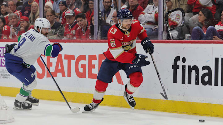 Oct 17, 2024; Sunrise, Florida, USA; Florida Panthers center Sam Reinhart (13) moves the puck past Vancouver Canucks right wing Conor Garland (8) during the third period at Amerant Bank Arena. Mandatory Credit: Sam Navarro-Imagn Images Oct 17, 2024; Sunrise, Florida, USA; Florida Panthers center Sam Reinhart (13) moves the puck past Vancouver Canucks right wing Conor Garland (8) during the third period at Amerant Bank Arena. Mandatory Credit: Sam Navarro-Imagn Images