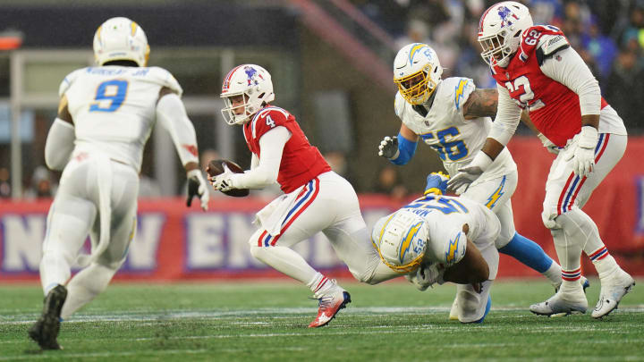 Dec 3, 2023; Foxborough, Massachusetts, USA; New England Patriots quarterback Bailey Zappe (4) is sacked by Los Angeles Chargers linebacker Khalil Mack (52) in the second half at Gillette Stadium. Mandatory Credit: David Butler II-USA TODAY Sports