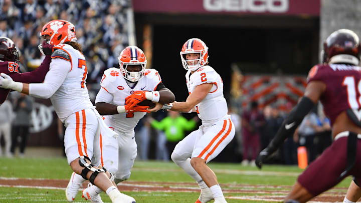 Nov 9, 2024; Blacksburg, Virginia, USA;  Clemson Tigers quarterback Cade Klubnik (2) hands the ball off to Clemson Tigers running back Phil Mafah (7) against the Virginia Tech Hokies during the first quarter at Lane Stadium. Mandatory Credit: Brian Bishop-Imagn Images