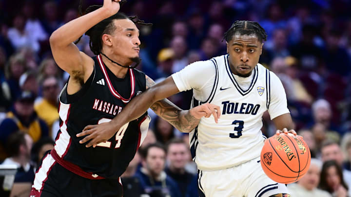 Mar 13, 2026; Cleveland, OH, USA; Toledo Rockets guard Sonny Wilson (3) drives to the basket against Massachusetts Minutemen guard Marcus Banks Jr. (24) during the first half at Rocket Arena Mandatory Credit: Ken Blaze-Imagn Images