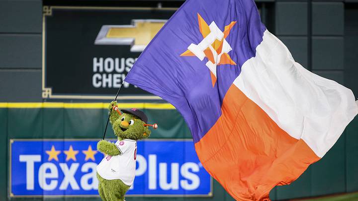 The Houston Astros mascot "Orbit" waves a flag The Houston Astros mascot "Orbit" waves a flag