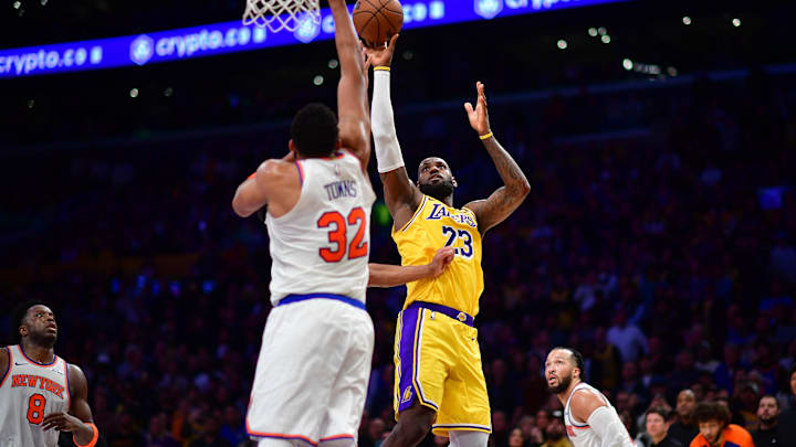 Mar 6, 2025; Los Angeles, California, USA; Los Angeles Lakers forward LeBron James (23) shoots against New York Knicks center Karl-Anthony Towns (32) during overtime at Crypto.com Arena. Mandatory Credit: Gary A. Vasquez-Imagn Images