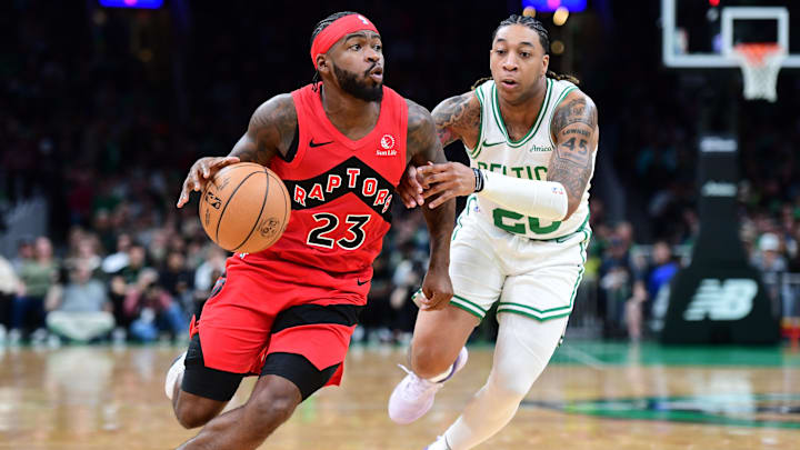 Toronto Raptors guard Jamal Shead (23) controls the ball while Boston Celtics guard JD Davison (20) defends during a preseason NBA game.