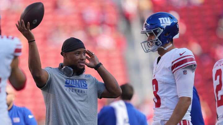 September 21, 2023; Santa Clara, California, USA; New York Giants running back Saquon Barkley (left) talks to quarterback Daniel Jones (8) before the game against the San Francisco 49ers at Levi's Stadium.  