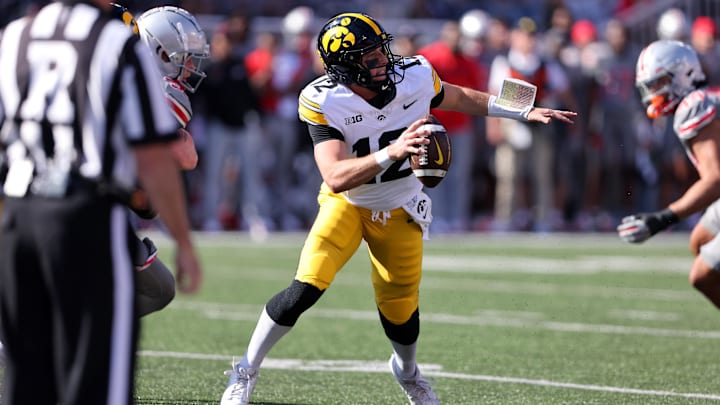 Oct 5, 2024; Columbus, Ohio, USA;  Iowa Hawkeyes quarterback Cade McNamara (12) drops back to throw against the Ohio State Buckeyes during the first quarter at Ohio Stadium. Mandatory Credit: Joseph Maiorana-Imagn Images