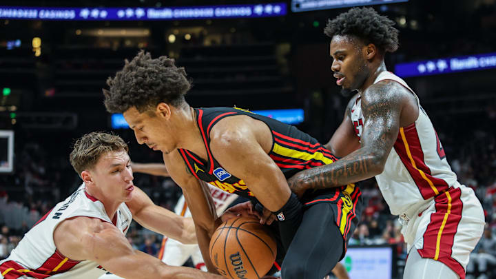 Dec 26, 2025; Atlanta, Georgia, USA; Atlanta Hawks forward Jalen Johnson (1) fights for the ball against Miami Heat guard Pelle Larsson (9) and Miami Heat guard Davion Mitchell (45) during the fourth quarter at State Farm Arena. Mandatory Credit: Jordan Godfree-Imagn Images Dec 26, 2025; Atlanta, Georgia, USA; Atlanta Hawks forward Jalen Johnson (1) fights for the ball against Miami Heat guard Pelle Larsson (9) and Miami Heat guard Davion Mitchell (45) during the fourth quarter at State Farm Arena. Mandatory Credit: Jordan Godfree-Imagn Images