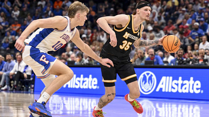 Mar 14, 2025; Nashville, TN, USA;  Missouri Tigers guard Jacob Crews (35) drives to the basket past Florida Gators forward Thomas Haugh (10) during the second half at Bridgestone Arena.