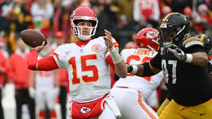 Dec 25, 2024; Pittsburgh, Pennsylvania, USA; Kansas City Chiefs quarterback Patrick Mahomes (15) throws a pass while being pressured by Pittsburgh Steelers defensive tackle Cameron Heyward (97) during the first quarter at Acrisure Stadium. Mandatory Credit: Barry Reeger-Imagn Images