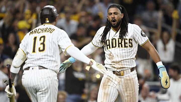 Sep 29, 2026; San Diego, California, USA;  San Diego Padres outfielder Fernando Tatis Jr. (23) celebrates with third baseman Manny Machado (13) after scoring against the Chicago Cubs during the seventh inning during game one of the Wildcard round for the 2026 MLB Playoffs at Petco Park.  Mandatory Credit: Denis Poroy-Imagn Images