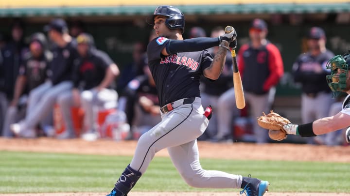Mar 30, 2024; Oakland, California, USA; Cleveland Guardians shortstop Brayan Rocchio (4) hits a double against the Oakland Athletics during the fourth inning at Oakland-Alameda County Coliseum. Mandatory Credit: Darren Yamashita-USA TODAY Sports