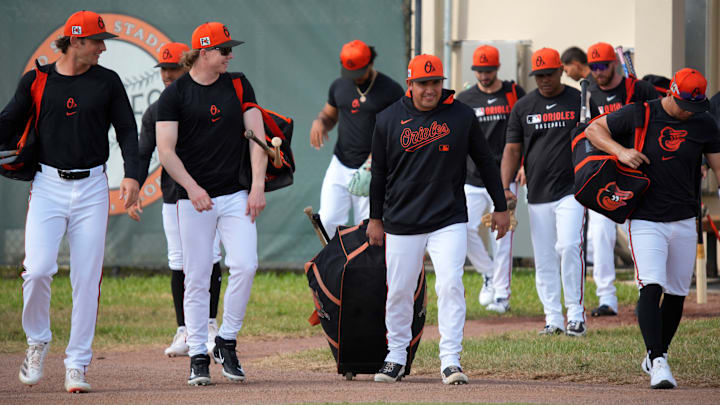Baltimore Orioles players and coaches emerge from the clubhouse to start their first full-squad workout of the 2025 spring training season on Tuesday, Feb. 18th in Sarasota, Florida. Baltimore Orioles players and coaches emerge from the clubhouse to start their first full-squad workout of the 2025 spring training season on Tuesday, Feb. 18th in Sarasota, Florida.