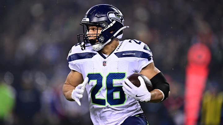 Dec 26, 2024; Chicago, Illinois, USA; Seattle Seahawks running back Zach Charbonnet (26) runs the ball against the Chicago Bears during the first quarter at Soldier Field. Mandatory Credit: Daniel Bartel-Imagn Images